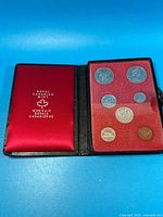 Closed case opened to show satin liner and coin display