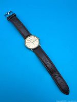 Full view of watch with strap showing overall condition