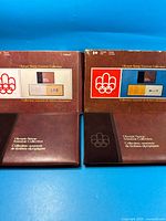 Both Olympic Stamp Souvenir Collection volumes with slipcases front view