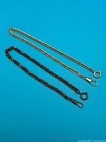 Both pocket watch chains laid flat