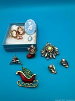 Group shot of all jewelry pieces against blue background