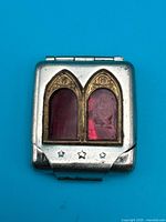 closed shrine front view showing arched red panels and stars on latch