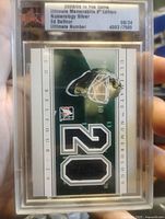 Front of sealed Ed Belfour Numerology Silver jersey patch card showing patch and serial number 08/24