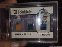 Front of slabbed Ed Belfour triple patch card showing three fabric swatches