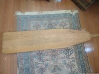 Top view of full ironing board on rug
