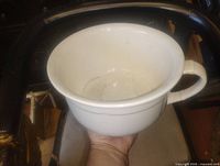 Top view of white chamber pot showing interior and rim