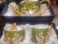 Teapot and lower pieces in silk-lined boxes