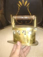 Full view of brass iron showing handle and vented sides