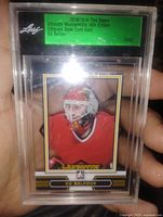 Front view of encased Ed Belfour Gold Ultimate Base Card showing player image and gold parallel design
