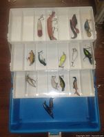 Open tackle box showing three trays and contents