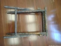 Top view of folded wooden stand showing rails and wear