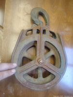 Front view of cast iron barn pulley with hook