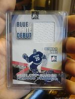 Front of Ed Belfour Blue and White Debut jersey patch card showing fabric swatch and design