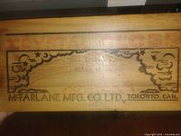 Front of wooden crate board showing Crystal Globe and McFarlane Mfg. Co. Ltd. graphics