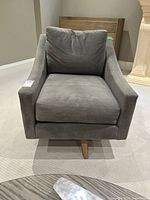 Front view of grey microfibre swivel armchair