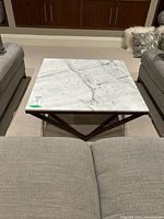 Top view of square marble coffee table showing marble veining and edge