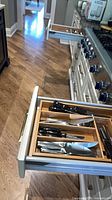 Drawer with Cutco and other knives visible