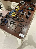 Overview of table with multiple cables, camcorder and graphics card