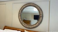 Full view of round Ethan Allen mirror mounted on wall