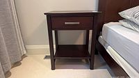 full view of Handstone side table beside bed