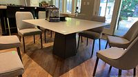 Full view of Trica square glass dining table with pedestal base