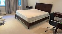 Complete bed showing frame, mattress, topper in room
