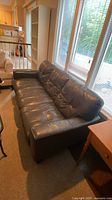 Front angled view of entire dark grey leather 3-seat sofa