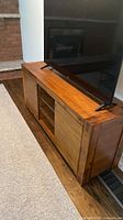 front view of solid wood media console with TV on top