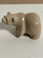Beige stone bear figurine side profile