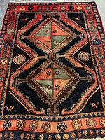 Full view of rug showing geometric medallion design and borders