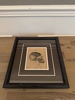 Full view of framed skull etching plate on floor