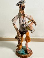 Full front view of fisherman figurine