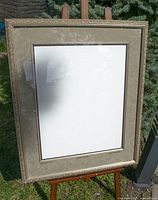 Full view of the framed assembly on easel