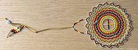 Full view showing entire beaded medicine wheel with hanger and bead string
