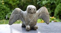 Front view of soapstone snowy owl with wings spread