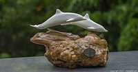 Front view showing both dolphins and base with maker medallion