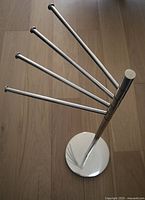 Full view of towel rack showing four swiveling arms and base