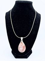 Pendant and chain displayed on bust