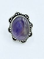 Front view of ring showing amethyst and scalloped bezel