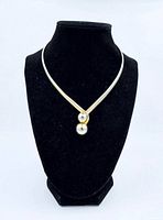 Front view of metal cuff necklace on display bust