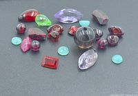 Mixed loose gemstones grouped on black background