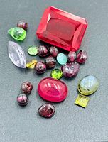 group of assorted loose gemstones on dark background