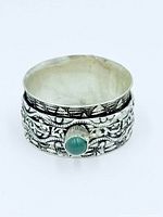 Front view of ring showing green onyx cabochon and ornate band