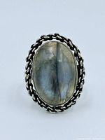 Front view showing oval labradorite and braided bezel