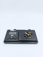 Gemstones on digital scale tray with readout covered by stones