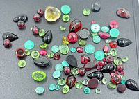 Group of assorted colored gemstones on black background