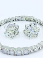 Bracelet detail showing clasp signed Monet and crystal earrings