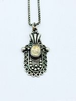 Front view close-up of sterling silver pendant on chain