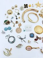 Overall view of mixed jewelry laid out on white background