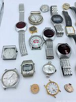 Group shot of entire assortment of wristwatches on white background